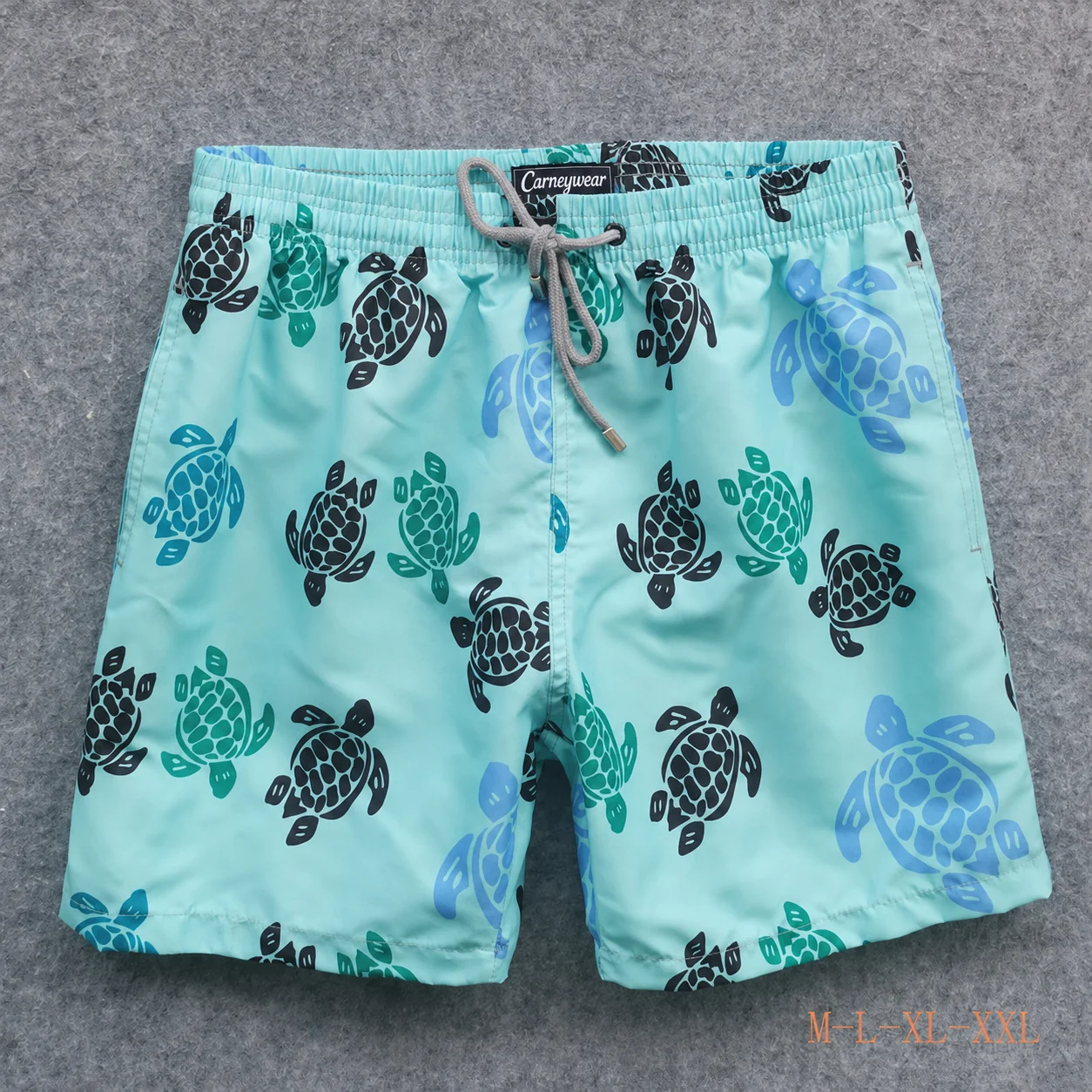 Front view of Aqua Turtle Print Board Shorts